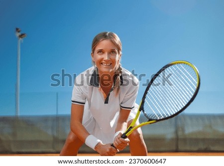 Tennis player woman with racket on the court outdoors. Download a photo of a tennis player girl to advertise sporting events in social media.
