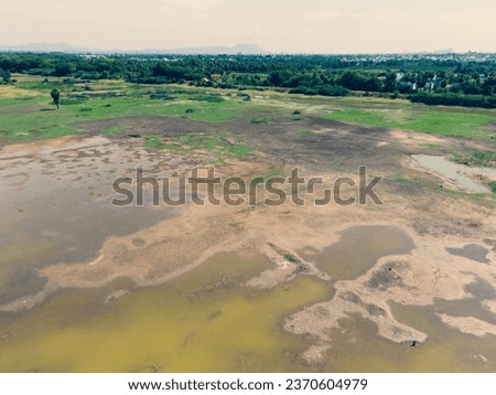 drone shot aerial view top angle panoramic photograph drought dry lake pond reservoir red soil potholes wallpaper background agricultural fields lands cultivation madurai Tamilnadu india submerged
