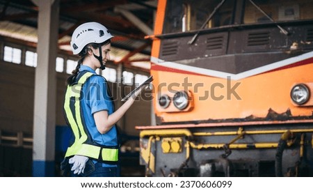 Industrial engineers inspect and perform maintenance on the machines at factory machines. Teamwork in the Manufacturing Industry in the train garage. Royalty-Free Stock Photo #2370606099