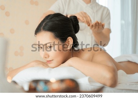 Portrait of young beautiful Asian woman having massage and spa salon Beauty treatment concept. She is very relaxed. Body care, Massage relax, aromatherapy, sauna