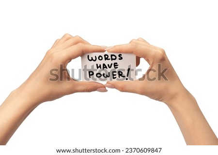 Words have power text on a card in a woman hand isolated on a white background.