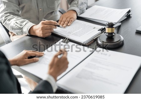Lawyer Legal counsel presents to the client a signed contract with gavel and legal law. justice and lawyer Business partnership meeting concept.