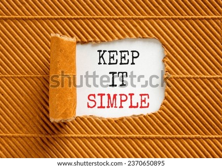 Keep it simple symbol. Concept word Keep it simple on beautiful white paper. Beautiful brown table brown background. Business motivational keep it simple concept. Copy space.