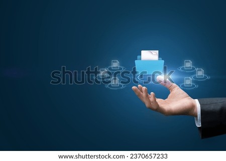 A businessman hand shows a documentary management system. Royalty-Free Stock Photo #2370657233