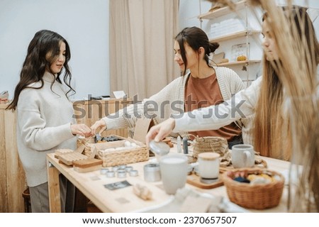 An employee of an eco store presents products, offering a large selection. Picture in beige tones