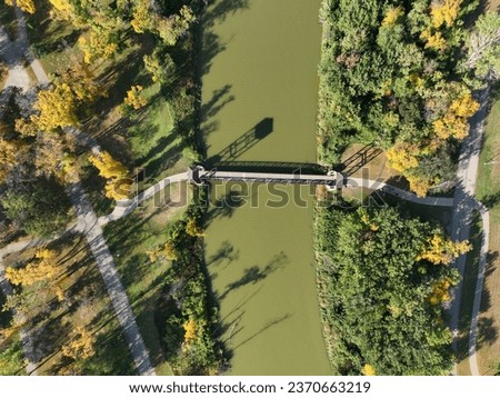 Top down drone picture of the walking bridge that connects Gooseberry and Lindenwood Parks. Can see some of the beautiful fall colors from the trees.