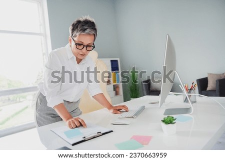 Photo of confident busy lady assistant wear white shirt reading document modern gadget indoors workplace workstation
