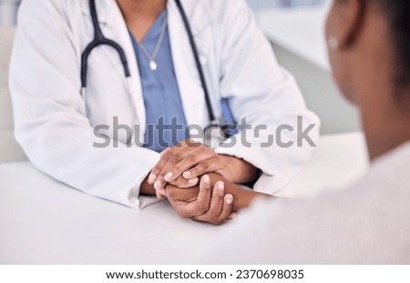 Healthcare, holding hands and doctor with woman in clinic for support. empathy or care. Checkup, discussion and closeup of female medical worker with sympathy for African patient in medicare hospital Royalty-Free Stock Photo #2370698035