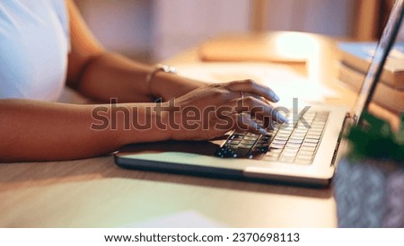 Laptop, business and closeup of hands typing, work on project and creative research at desk. Table, keyboard editor and woman writing email, networking on website and internet on computer in startup