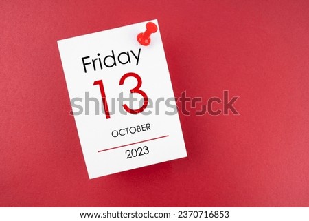 Calendar Friday the 13th October 2023 and push pin on red background. Royalty-Free Stock Photo #2370716853