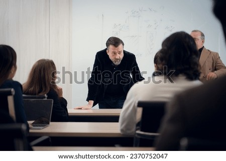 Portrait of a senior businessman giving a presentation to his colleague at office