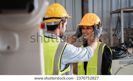 Engineers take care of each other in the workplace. Workers are controlling the automated robot arms machine welding steel welding robots. Royalty-Free Stock Photo #2370752827