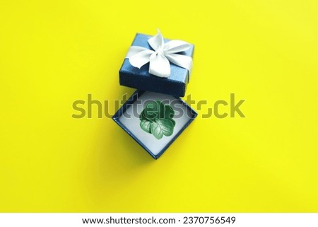 St. patrick's day background. Religious Christian Irish celebration. Four-leaf clover symbol of good luck with gift box.