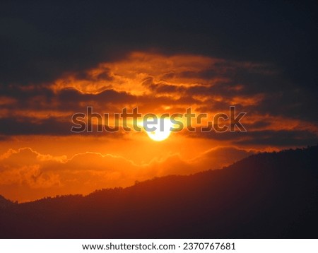 Aesthetic sunset photo: the sun is about to set with the silhouette of clouds and Mount Salak, Indonesia