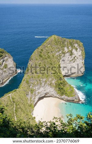 Aerial view of Kelingking Beach T-Rex Head Beach with rocky mountains and clear water in Nusa Penida, Bali, Indonesia.