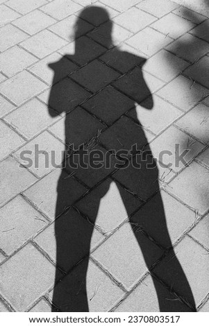 Shadow woman, silhouette of woman, person, concrete pavement, black and white photo