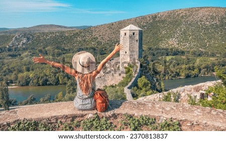 Tour tourism, travel, vacation in Bosnia- Woman enjoying panorami view of old castle in Pocitelj Royalty-Free Stock Photo #2370813837