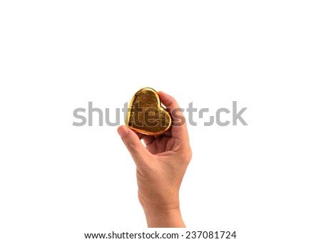 gold heart in hand holding  isolated on white
