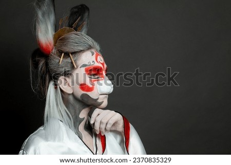 Young woman rabbit portrait. Halloween makeup and costume