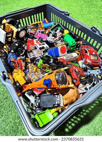 "TOYS TO BE THROWN AWAY". The picture shows a pile of children's toys of various types, of various colors waiting to be thrown away. Some are still good, some are damaged. Royalty-Free Stock Photo #2370835631