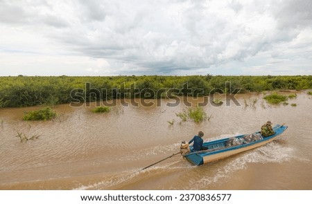Tonle Sap lake, Siem reap Province, Cambodia. Fisherman in his boat, Floating village of Kompong Phluk, Cambodia.