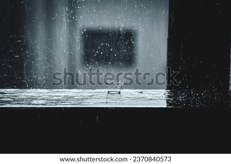 Rainy weather. Raindrops reflecting off the wooden railing of the terrace. A storm and a shower Royalty-Free Stock Photo #2370840573