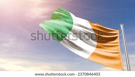Ireland national flag waving in beautiful sky. The flag waving with dynamic angle.