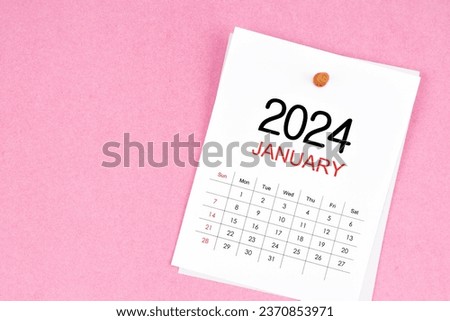 January 2024 calendar page and wooden push pin on pink Color background. Royalty-Free Stock Photo #2370853971