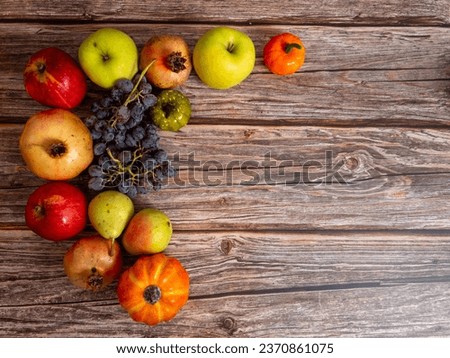 Autumn still life . Different fruits , vegetables and pumpkin on the wooden table