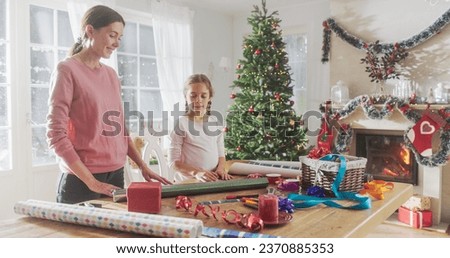 Portrait of Mother and Daughter Wrapping Gifts for Christmas at Home. Cute Little Girl Choosing Decorations for Gift Boxes to Give to Family. Holiday Season Full of Love and Sharing