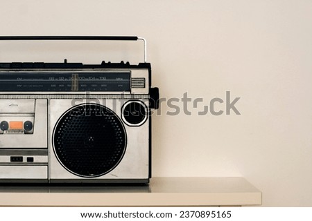 Old radio cassette background. Eighties music on portable radio. Image for music poster design Royalty-Free Stock Photo #2370895165