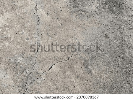 a rough concrete floor with a crack in it..