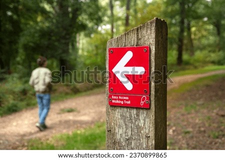 Easy Access Walking Trail sign on a wooden post, walking concept. Royalty-Free Stock Photo #2370899865