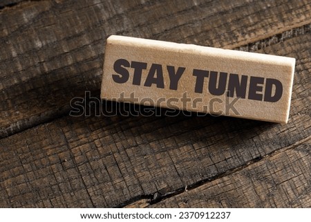 STAY TUNED words on a wooden block. Business concept