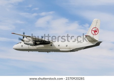Unbranded all-white cargo propeller aircraft take off photo against the sky