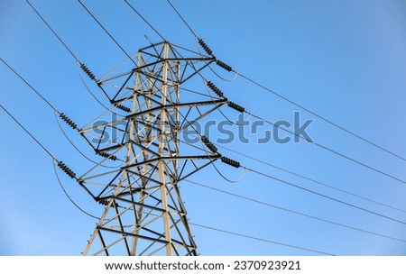 electricity transmission towers against a dramatic sky, symbolizing energy, connectivity, and technological progress Royalty-Free Stock Photo #2370923921