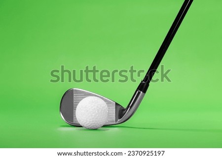 Fairway Iron Golf Club with Ball on a Green Background with Copy Space