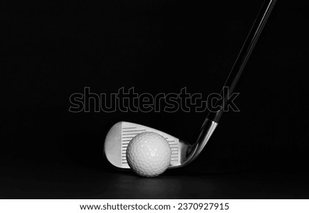 Golf Club Iron and Ball pictured on a Black Background with Surface Showing, Studio Shot with Copy Space