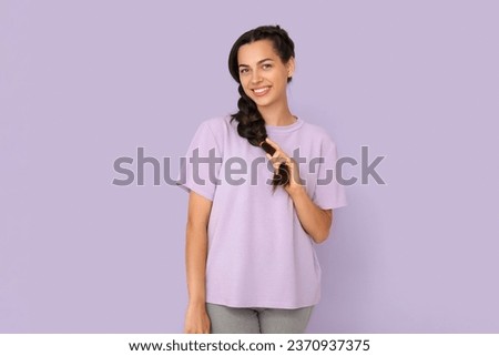 Young woman in t-shirt on lilac background