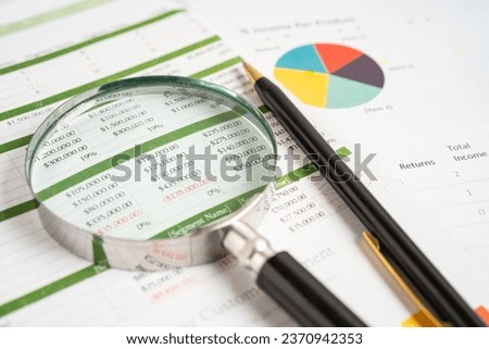 Magnifying glass on graph paper. Financial development, Banking Account, Statistics, Investment Analytic research data economy, Business concept. Royalty-Free Stock Photo #2370942353