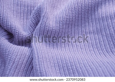Lilac purple knitted woolen sweater fabric. Abstract background.