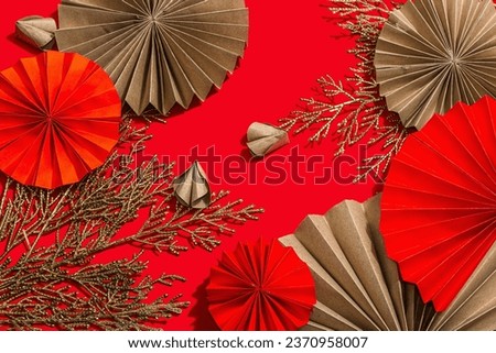Happy Chinese New Year traditional concept. Oriental asian style paper fans on red background, minimal concept, flat lay, top view