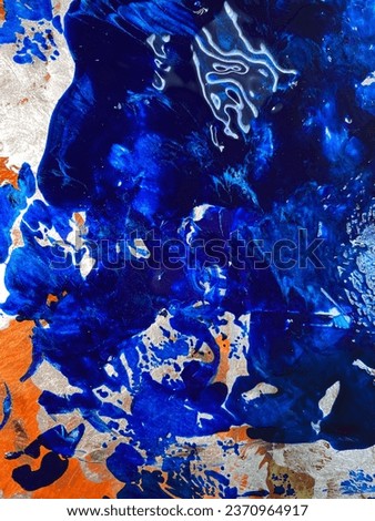 Abstract painting with metallic paint with mother-of-pearl and sequins in blue tones similar to a stormy ocean