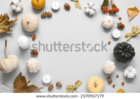 Frame made of candles and beautiful autumn decor on grey background