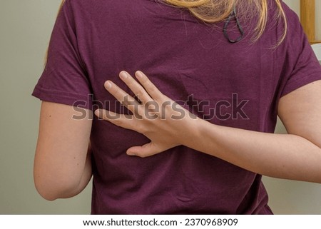 Pain in the shoulder blade, the woman holds her back on one side Royalty-Free Stock Photo #2370968909