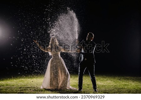 night picture, where the bride and groom open champagne and everything goes in the air