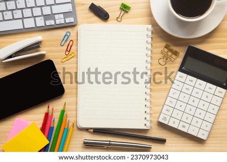 wood desk office with laptop, smartphone and other work supplies with cup of coffee. Top view with copy space for input the text. Designer workspace on desk table essential elements on flat lay. Royalty-Free Stock Photo #2370973043