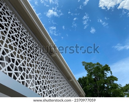 Islamic, Muslim building featuring modern Arabesque design. pattern inspired by ancient Arabian Middle Eastern civilization, culture and religion. blue sky and copy space