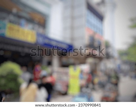 abstract blur photo of Unacquainted people walking and shopping in Bandung-Indonesia