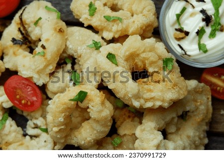 Calamari is a typical Mediterranean dish made from squid cut into rings and coated in flour and then fried. and generally calamari is served with tartar sauce.